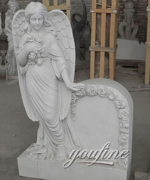 Outdoor cemetery white marble angel tombstone with flower carved